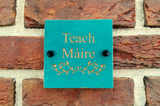 Turquoise ceramic tile address sign engraved with house name and decorative floral motif underneath. Engraving paint options include gold, copper, silver and black. 