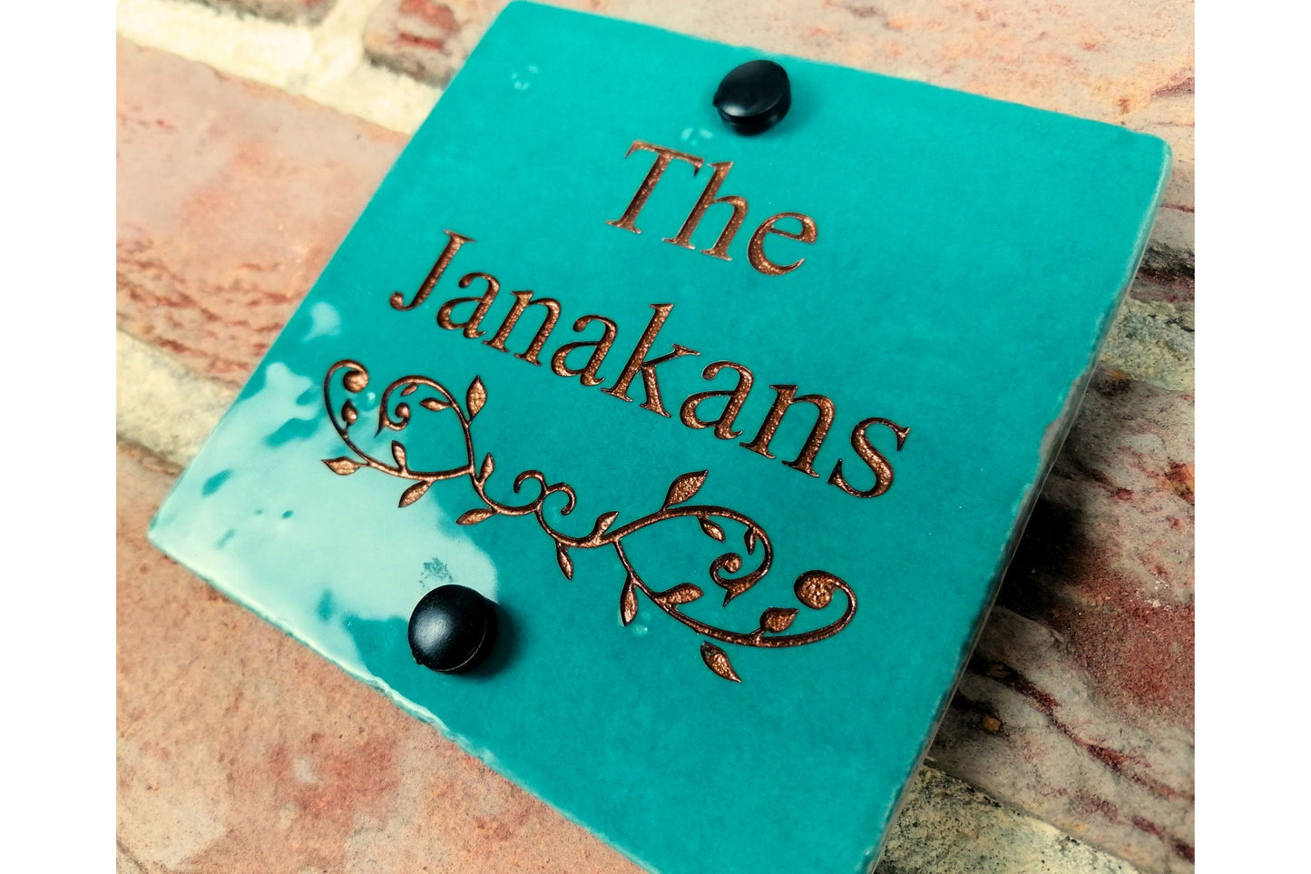 Turquoise ceramic tile address sign engraved with house name and decorative floral motif underneath. Engraving paint options include gold, copper, silver and black.